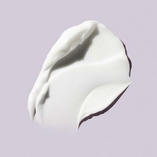 A dollop of white cream or yogurt on a light purple background.