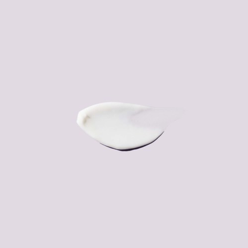 A white cream or gel on a light purple background, shaped like a small dollop.