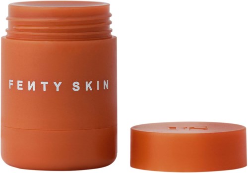 Iso oranssi purkki, jossa on irtonainen kansi ja valkoinen teksti, merkki Fenty Skin, näyttää olevan ihonhoitotuote.