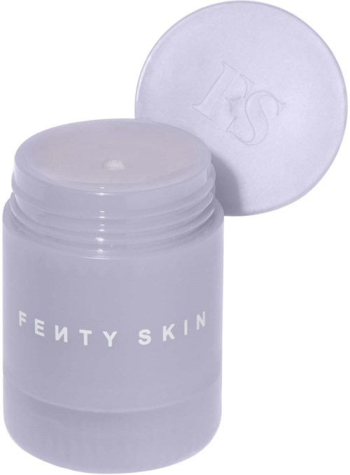 En lila Fenty Skin-krämkruka med öppen lock, visar insidan. Krukan har vitt text på sig.