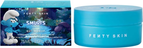 A blue jar of Fenty Skin Smurfs Butter Drop body cream with Smurf and mushroom characters on the box.