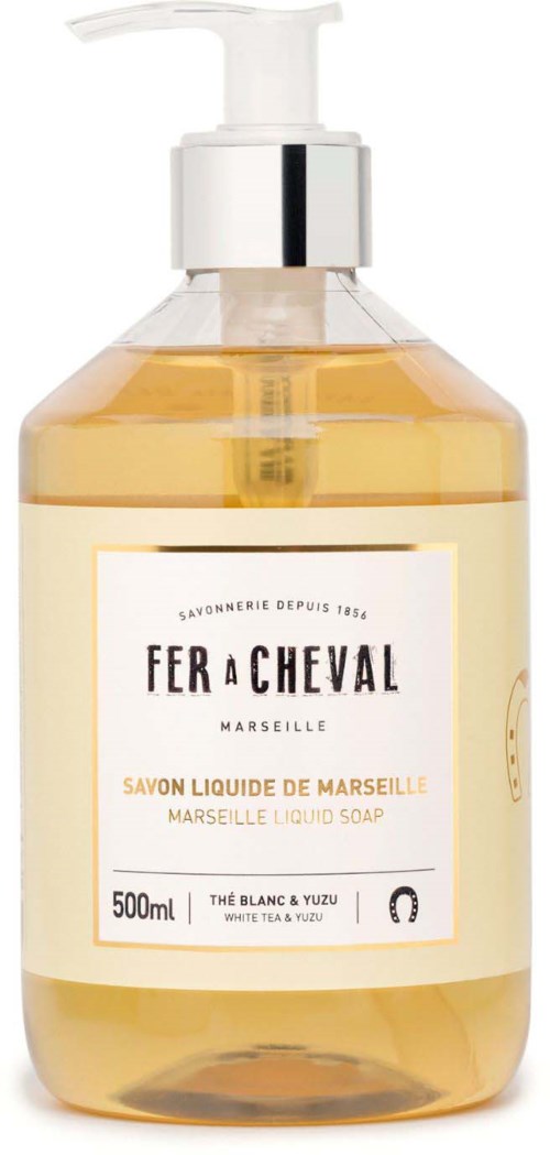 A transparent bottle with soap, labeled "Fer a Cheval," containing 500ml of Marseille liquid soap with a pump.