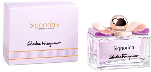 A perfume bottle with a pink bow on top, next to a white box with gold and black lettering.