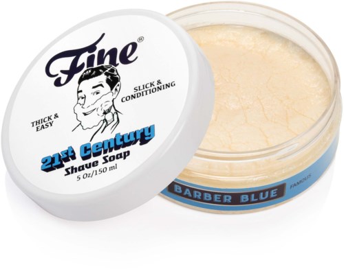 Een ronde container scheerzeep met deksel die een man en tekst toont, en de zeep binnen is beige.