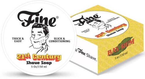 Rund sæbe med ansigtsillustration, mærket som 21st Century Shave Soap, i en gul og hvid æske.