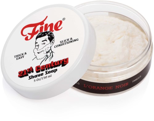 A container of shaving soap labeled '21st Century', with black and red text and a smiling man illustration.