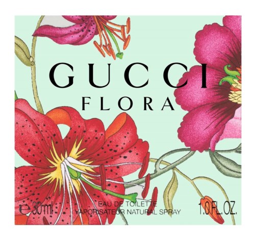 Ett mönster med stora rosa och röda blommor och texten 'GUCCI FLORA' i mitten.