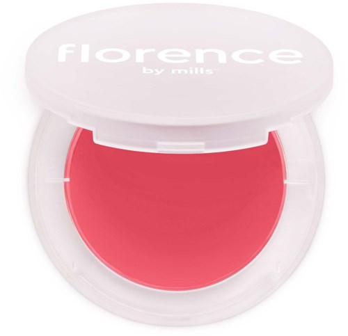 A small round container with pink blush and a white lid that says 'florence by mills' on it.