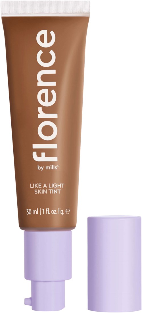 A tube of skin tint cream labeled 'Florence by Mills' with brown contents and a purple cap.