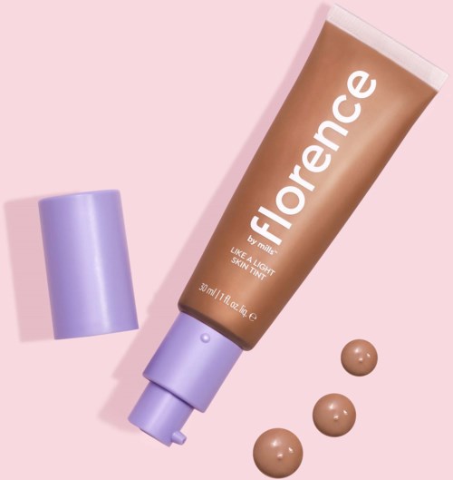 A tube labeled 'Florence' with purple cap and three small swatches of beige foundation. Light pink background.