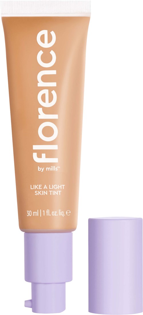 A peach-colored tube labeled 'FLORENC' with white text, and a lavender cap next to it. It is a skin tint product.