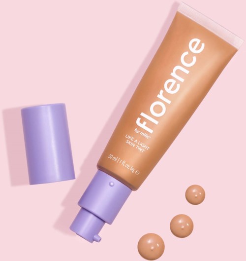 A tube of Florence skincare product with a purple cap and three dollops of cream on a pink background.