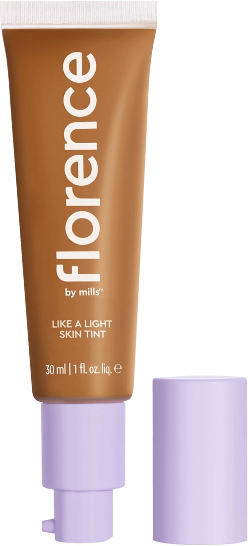 Orange tube labeled 'Florence by Mills' with white cap beside it, containing light skin tint.