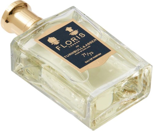 Szklana butelka perfum z złotym korkiem i etykietą z napisem 'Floralis Turnbull Lasseur 77/72 Eau de Parfum'.