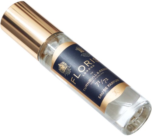 A perfume bottle with a blue label and gold cap, labeled 'Floris London,' containing perfume.