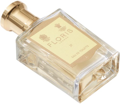 En tydlig parfyllflaska med gulddetaljer och en beige etikett med texten 'Floris London Eau de Toilette.'