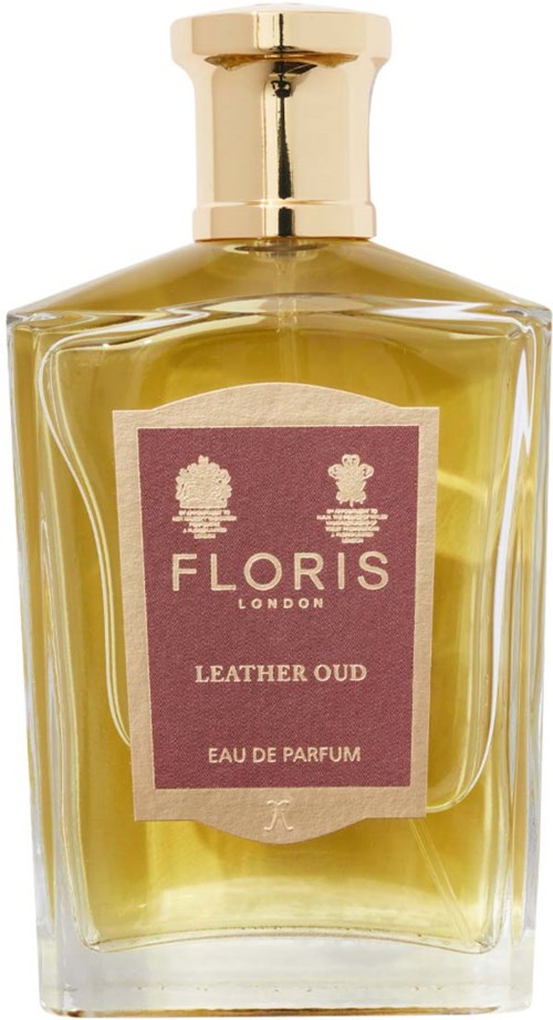 En glassparfyreflaske med gullhåndtak inneholder gulgrønn duftvæske. Etiketten sier Floris London, Leather Oud, Eau de Parfum.