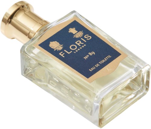 En parfymflaska märkt Floris London, No. 89, Eau de Toilette, med ett guldlock och blå etikett.