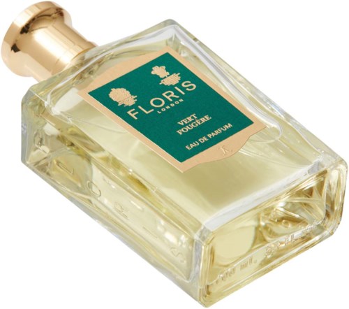 A clear perfume bottle with a gold cap, labeled from Floris London, filled with light yellow liquid.