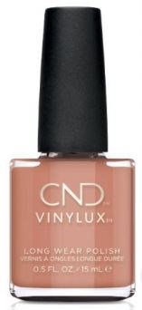 En flaska med CND Vinylux långvarig nagellack i en mjuk persikofärg.