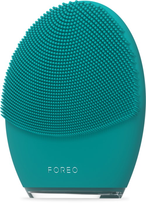 En turkos hudvårdsapparat med en strukturerad, spetsig yta och varumärket 'FOREO' längst ner.