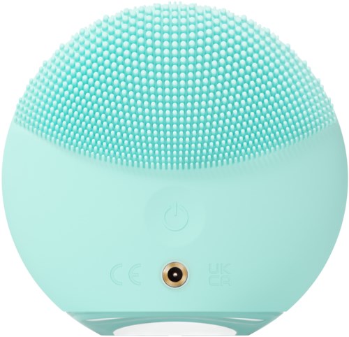 A round, light blue device with a textured, soft top and a power button, likely a skincare or facial device.
