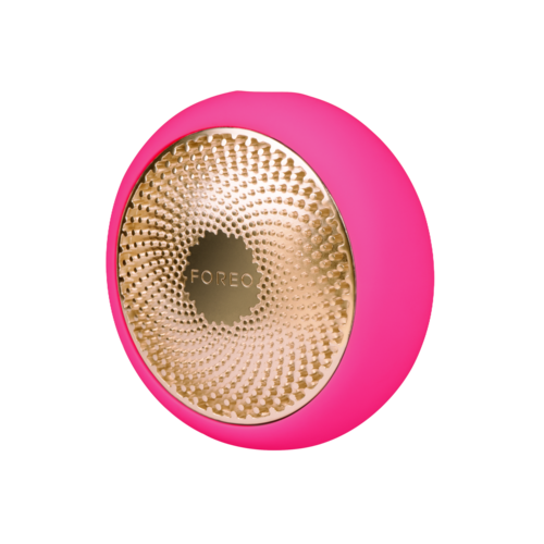 En rund enhet med rosa ytterkappe og en gylden teksturert overflate, merket 'FOREO'.