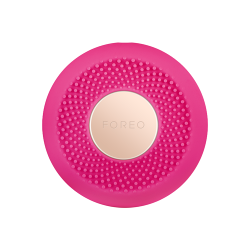 Ljusrosa cirkulär hudvårdsapparat med små knoppar och vit mittdel märkt 'FOREO'.
