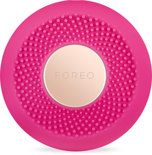 En rosa, rund ansiktsrengöringsapparat med små gummiborstar och varumärket 'FOREO' i mitten.