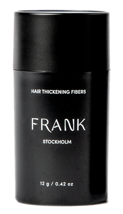 Svart flaska med vit text om hårfiber, inklusive varumärket Frank och produktens vikt.