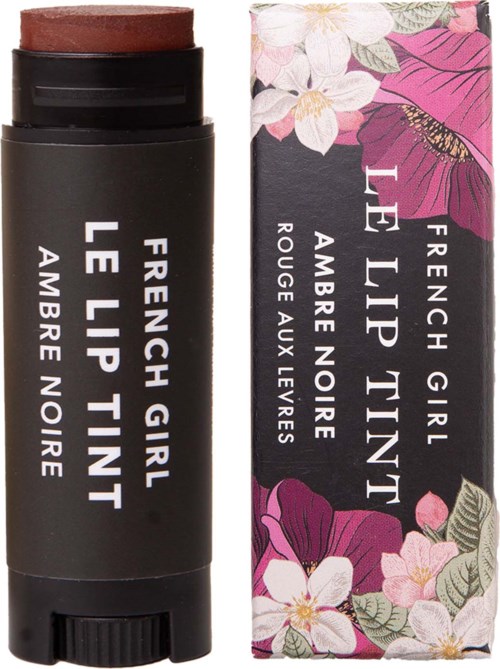 A lip balm in a black tube with a floral box featuring pink and white flowers and a butterfly.