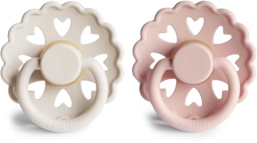 Two baby pacifiers with heart-shaped cutouts and round handles, one in cream and the other in pink.