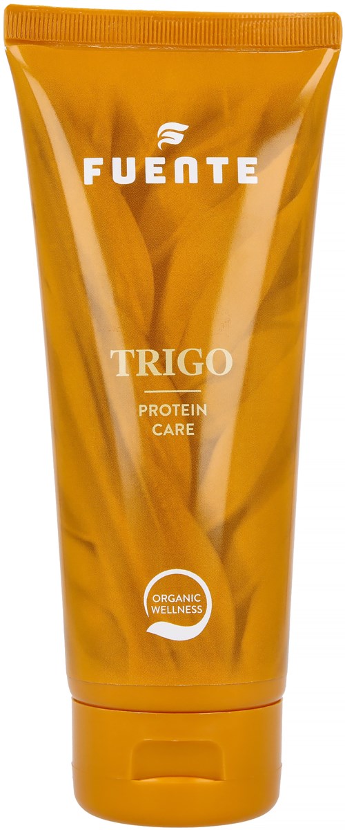 Den orange tuben har varumärket 'FUENTE' med 'TRIGO' och 'PROTEIN CARE' skrivet på den. Den har en rund symbol med 'ORGANIC WELLNESS' inuti.