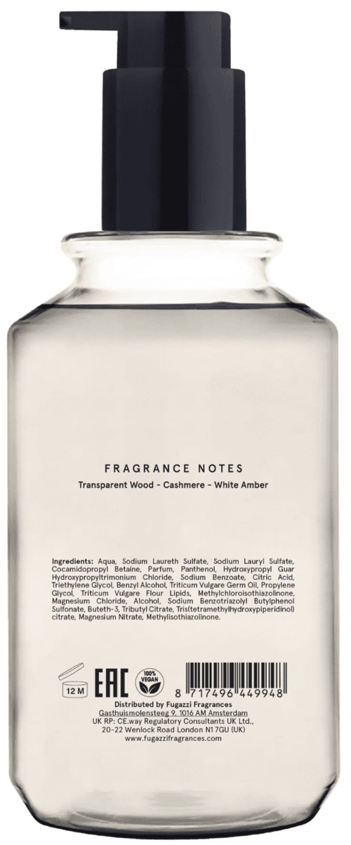 A clear bottle with a black pump, labeled with fragrance notes and ingredients, and a barcode at the bottom.