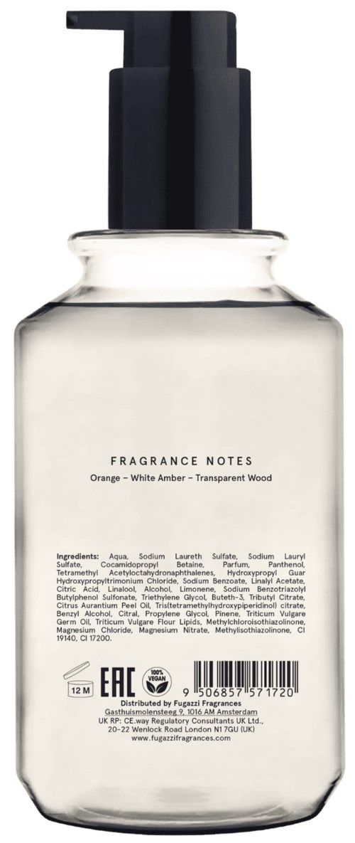 En klar flaske med sort pumpe, mærket 'Fragrance Notes' med duftbeskrivelse som inkluderer appelsin, hvid rav og gennemsigtigt træ.