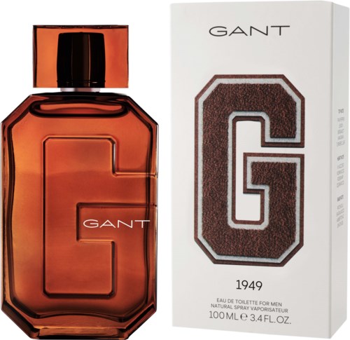 En GANT-parfymeflaske i ravfarge ved siden av en eske med et stort G og GANT-logo.