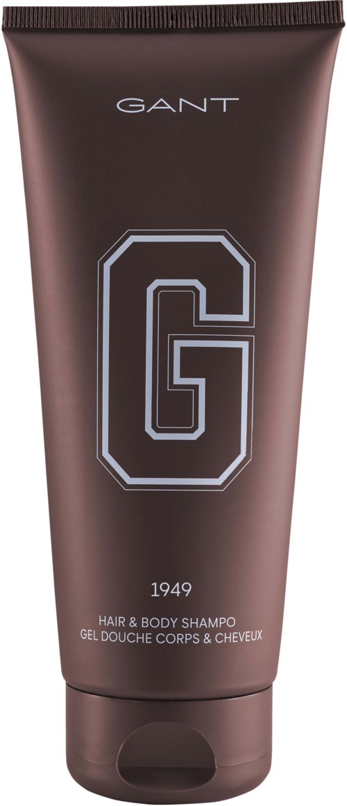 En brun tube merket 'GANT 1949 HAIR & BODY SHAMPOO' med en stor 'G'-logo i midten.