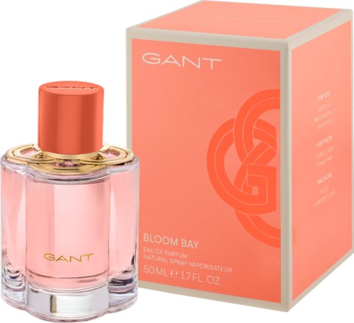 Pink perfume bottle and orange box, with gold accents and GANT branding, for Bloom Bay fragrance.