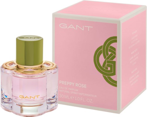 A pink perfume bottle with a green cap next to a pink box with green design, labeled GANT Preppy Rose.