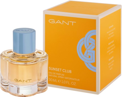 En parfymeflaske med blått lokk og gul væske, ved siden av en oransje boks merket GANT Sunset Club.