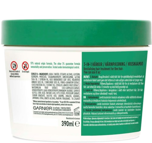 Grön lock, vit burk, svart text, nämner hårbehandling, Garnier, 390 ml storlek.