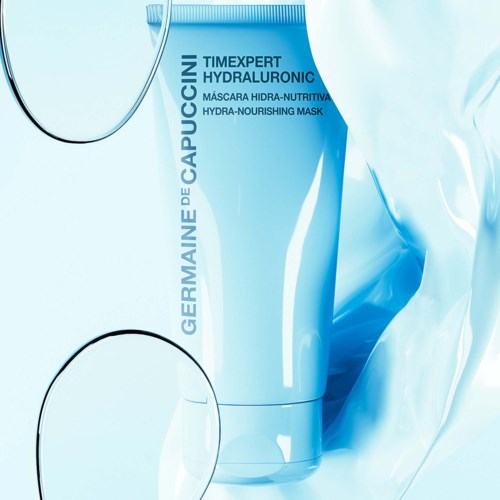 En blå tube med Hydra-Nourishing Mask och vattensplascher runt den.