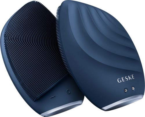 Two blue facial cleansing brushes with textured surfaces and the brand name Geske on one. They are rounded and sleek.