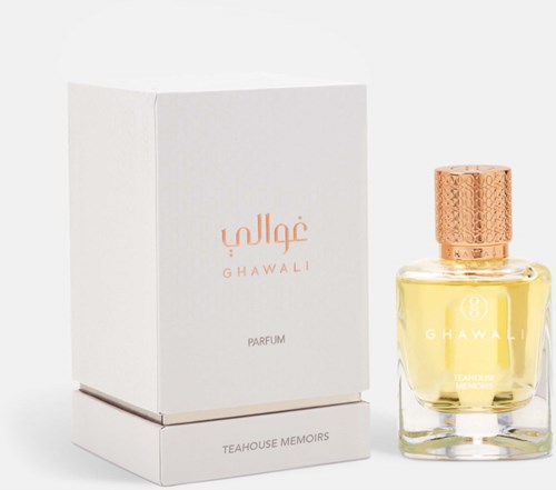 A perfume bottle with a gold textured cap next to a white box with pink text and logo, on a plain white background.