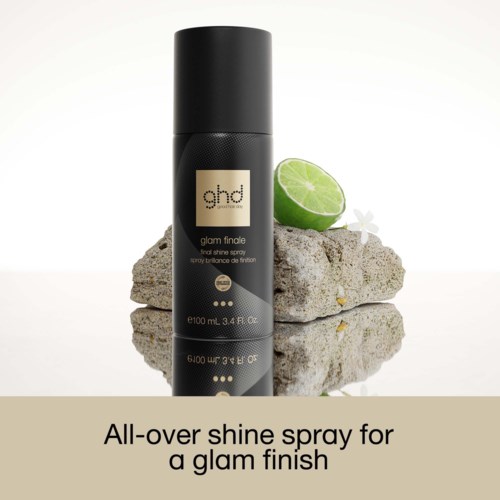 Ghd Haarspray auf Steinen mit Limette und weißer Blume, verleiht Glanz für einen glamourösen Look.