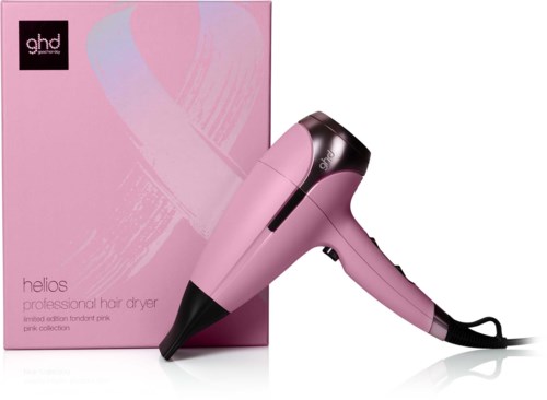 A pink GHD Helios hair dryer with a black handle, placed next to a pink box. The box and dryer are in matching pink shades.
