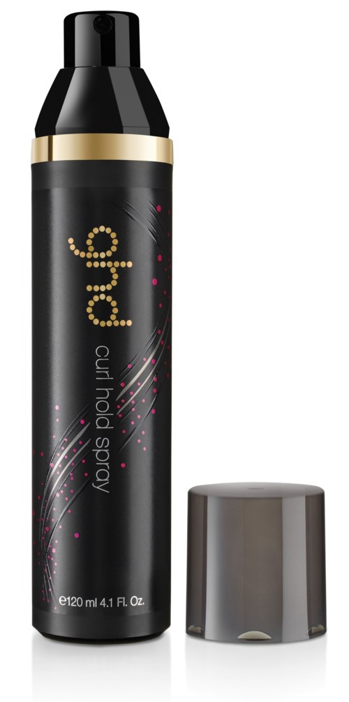 En svart burk med lock för lockhåsspray med ett guldband och en silverfärgad lock som står bredvid.