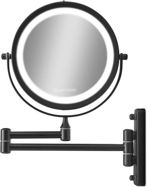 A round mirror with a black frame, mounted on a wall with adjustable arm. The mirror is labeled Gillian Jones.