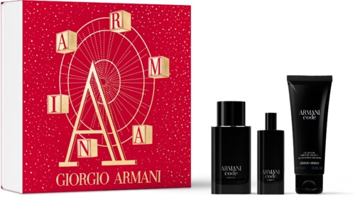 Ett presentset med en röd box och svarta flaskor, med Giorgio Armanis logga och design.