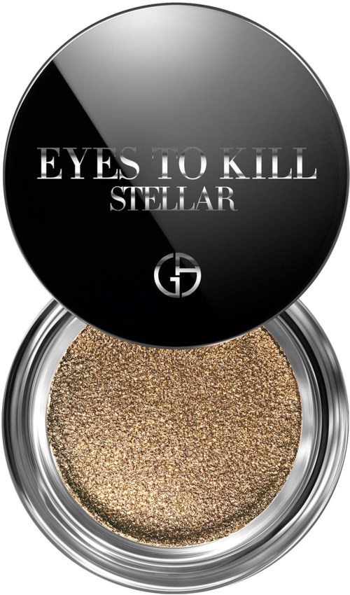 En rund beholder med gullfarget øyeskygge med svart lokk som viser teksten "EYES TO KILL STELLAR."